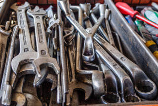 Junk drawer filled with tools.