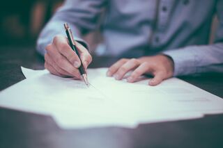 Insurance broker filling out paper work to file a claim.
